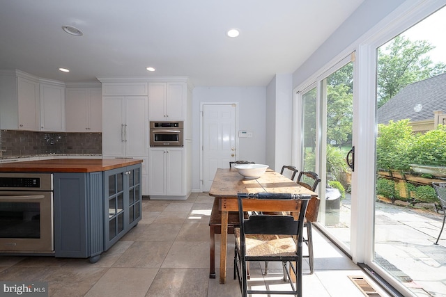 431 Waynesbrooke Rd, Berwyn, PA 19312 - kitchen with stainless steel oven, butcher block countertops, tasteful backsplash, recessed lighting, and gray cabinets