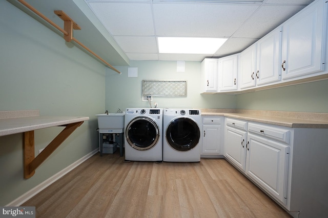 431 Waynesbrooke Rd, Berwyn, PA 19312 - laundry area with washing machine and dryer, cabinet space, and light wood-type flooring