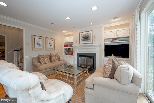 431 Waynesbrooke Rd, Berwyn, PA 19312 - living area featuring ornamental molding, built in shelves, a glass covered fireplace, and recessed lighting