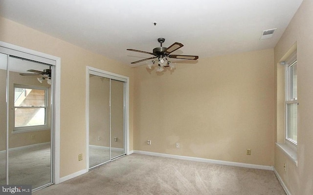 13406 Shady Knoll Dr Unit 105/G1, Silver Spring, MD 20904 - unfurnished bedroom featuring light carpet, two closets, and ceiling fan
