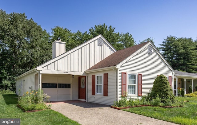 59 Saint Davids Pl, Southampton, NJ 08088 - view of front of home featuring board and batten siding, a garage, asphalt driveway, a chimney, and a front yard
