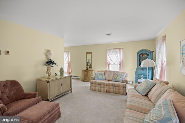 59 Saint Davids Pl, Southampton, NJ 08088 - living area featuring a baseboard heating unit, light colored carpet, and healthy amount of natural light
