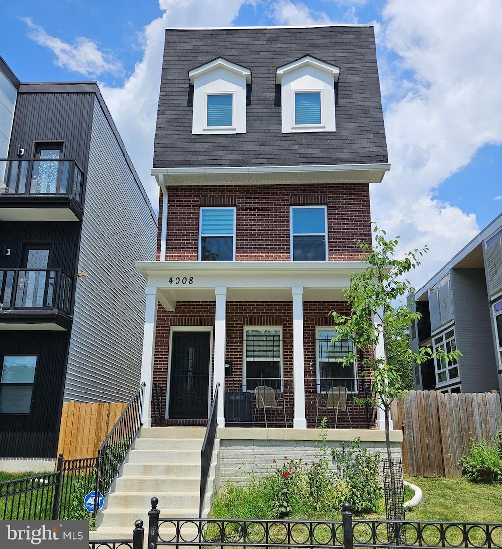 4008 9th St SE, Washington, DC 20032 - view of front facade with brick siding, covered porch, and a shingled roof