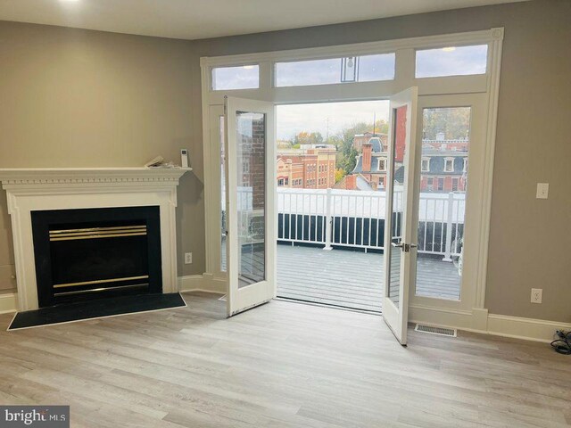 23 E Beverley St, Staunton, VA 24401 - entryway with wood finished floors, a fireplace with flush hearth, and french doors