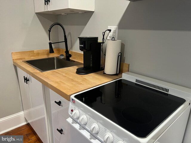 23 E Beverley St, Staunton, VA 24401 - kitchen with white range with electric stovetop, wood counters, and white cabinetry
