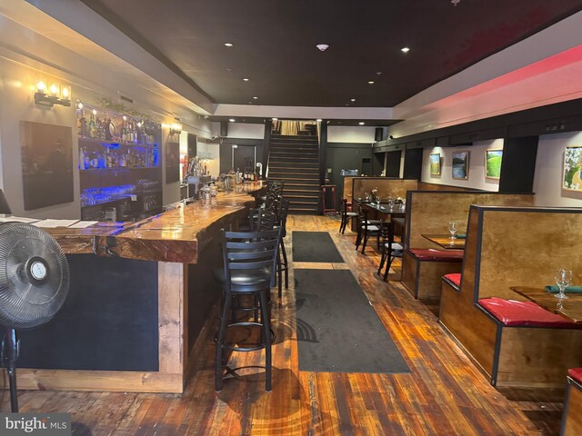 23 E Beverley St, Staunton, VA 24401 - indoor wet bar with dark wood finished floors and stairway