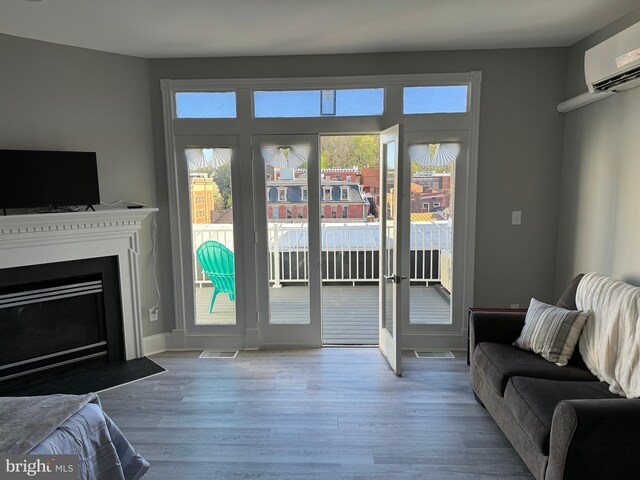 23 E Beverley St, Staunton, VA 24401 - doorway to outside featuring wood finished floors, a wall mounted AC, and a fireplace with flush hearth