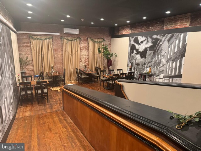 23 E Beverley St, Staunton, VA 24401 - bar area with brick wall, an AC wall unit, wood finished floors, and recessed lighting