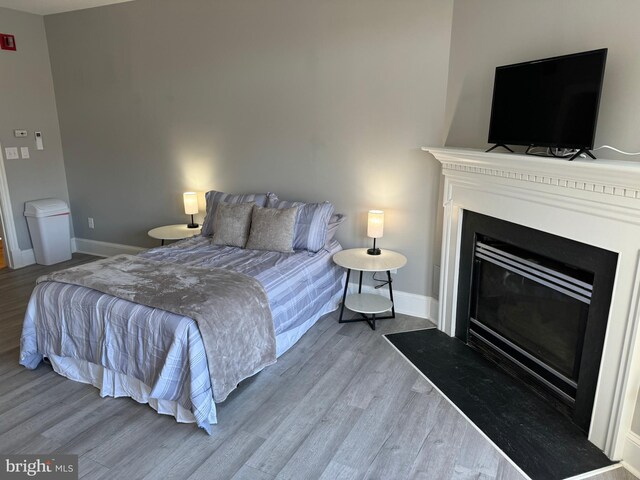 23 E Beverley St, Staunton, VA 24401 - bedroom with wood finished floors and a fireplace with flush hearth