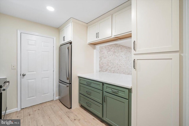 10264 Redtail Ct Unit 10264A, New Market, MD 21774 - kitchen with green cabinetry, freestanding refrigerator, light wood finished floors, light countertops, and white cabinets