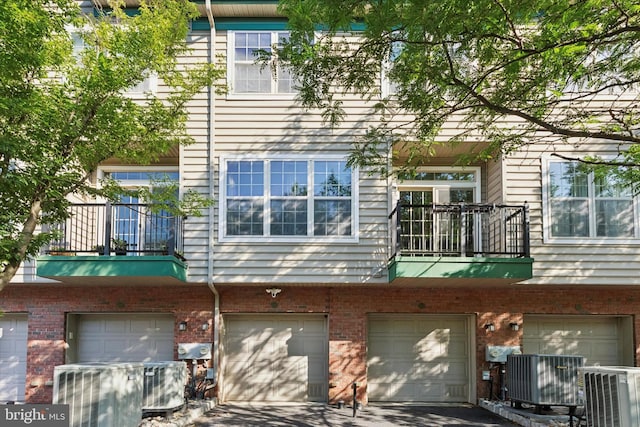 300 Jefferson Ave Unit 13, Downingtown, PA 19335 - back of house with a balcony, a garage, driveway, and brick siding