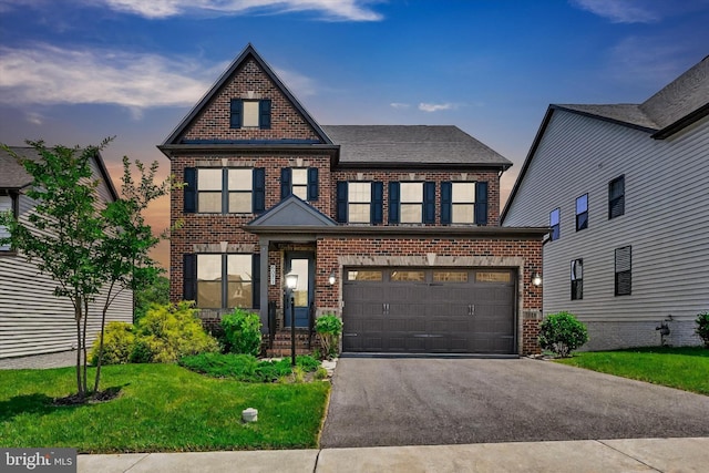 6071 Fallfish Ct, New Market, MD 21774 - view of front of house with brick siding, driveway, a front yard, and an attached garage