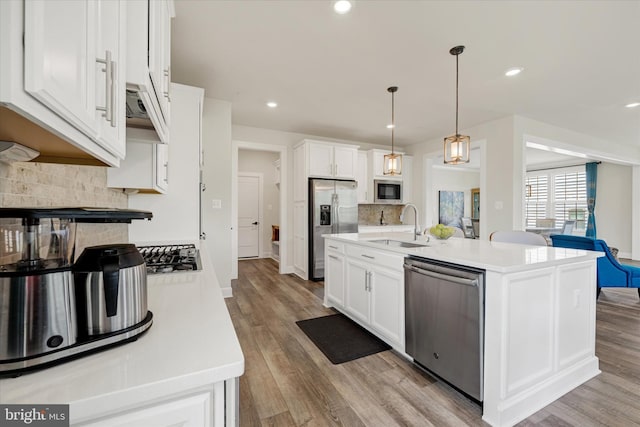 6071 Fallfish Ct, New Market, MD 21774 - kitchen featuring stainless steel appliances, tasteful backsplash, light wood-type flooring, light countertops, and white cabinets