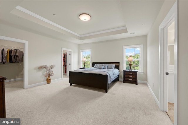 6071 Fallfish Ct, New Market, MD 21774 - bedroom featuring a walk in closet, a raised ceiling, light colored carpet, multiple windows, and crown molding