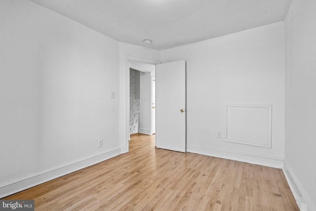 3402 Elmley Ave, Baltimore, MD 21213 - spare room with wood finished floors and a smoke detector