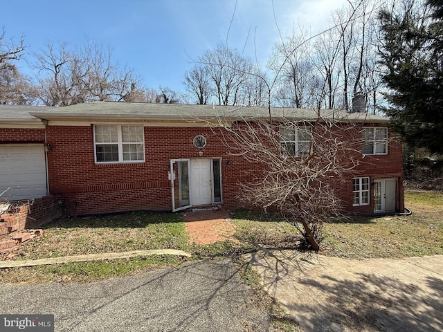 6231 8th St, Chesapeake Beach, MD 20732 - view of front of home featuring brick siding, a garage, and a front lawn