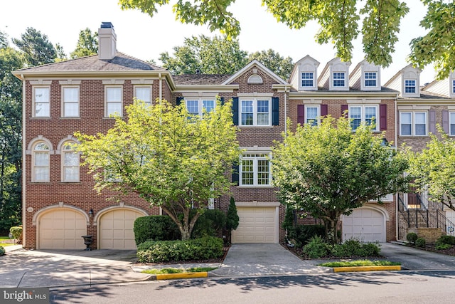 2153 Wolftrap Ct, Vienna, VA 22182 - view of front of house featuring brick siding, a garage, and driveway