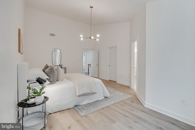 2153 Wolftrap Ct, Vienna, VA 22182 - bedroom with a chandelier, light wood-style floors, and a high ceiling