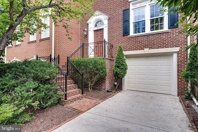 2153 Wolftrap Ct, Vienna, VA 22182 - doorway to property with a garage, concrete driveway, and brick siding