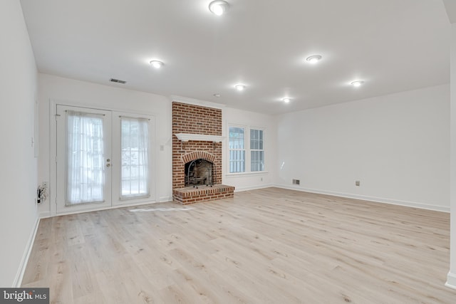 2153 Wolftrap Ct, Vienna, VA 22182 - unfurnished living room with light wood-style floors, french doors, and a fireplace