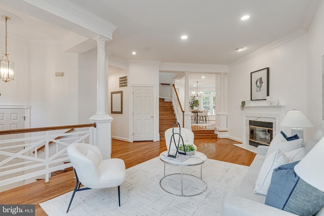 2153 Wolftrap Ct, Vienna, VA 22182 - living area with ornate columns, wood finished floors, stairs, crown molding, and recessed lighting
