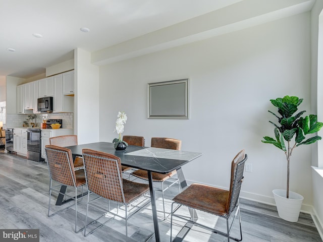 2103 E Cumberland St, Philadelphia, PA 19125 - dining room with light wood finished floors and baseboards