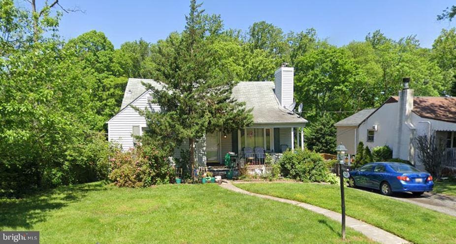 7508 Kenlea, Baltimore, MD 21236 - view of property hidden behind natural elements featuring a porch and a front yard