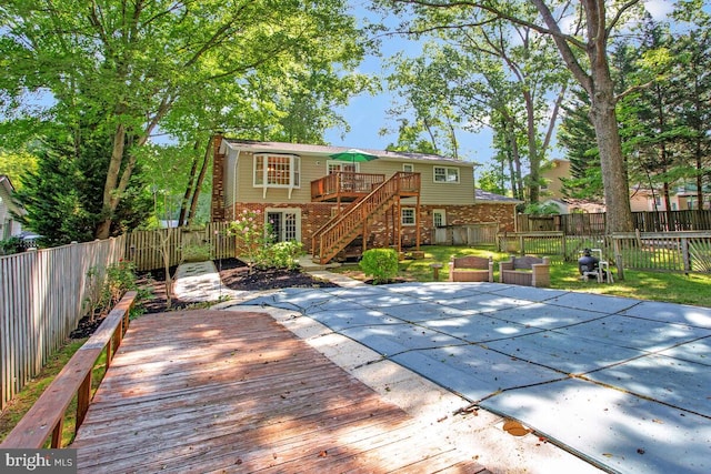 3077 Eutaw Forest Dr, Waldorf, MD 20603 - back of property featuring a wooden deck, a fenced backyard, brick siding, and stairway