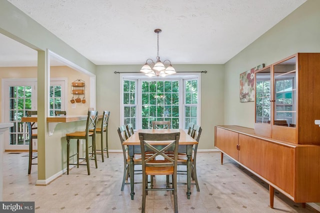 3077 Eutaw Forest Dr, Waldorf, MD 20603 - dining space featuring a chandelier, a textured ceiling, and light floors