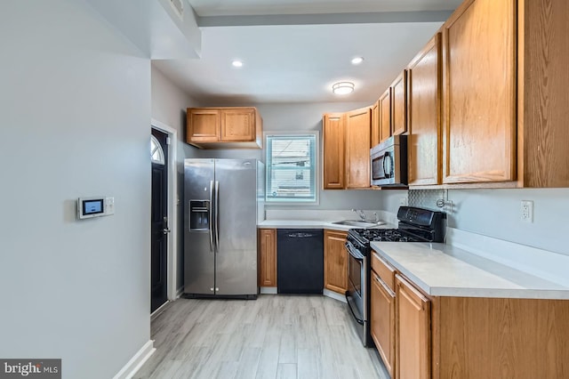 1901 Gwynns Falls Pkwy, Baltimore, MD 21217 - kitchen featuring stainless steel appliances, light countertops, brown cabinets, light wood-style flooring, and recessed lighting