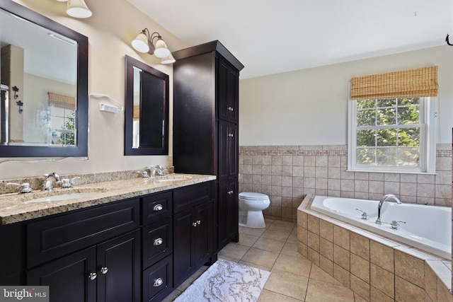 3960 Mountain View Ave, Easton, PA 18045 - bathroom with tile patterned flooring, double vanity, a bath, wainscoting, and tile walls