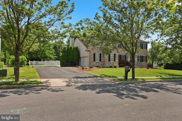 3960 Mountain View Ave, Easton, PA 18045 - view of front of house featuring asphalt driveway, a chimney, a garage, and stone siding