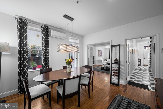 210 S High St, Baltimore, MD 21202 - dining area featuring a wall mounted air conditioner and hardwood / wood-style flooring