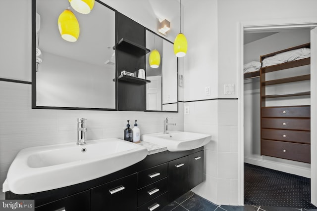 210 S High St, Baltimore, MD 21202 - bathroom with double vanity, tile patterned floors, and tile walls