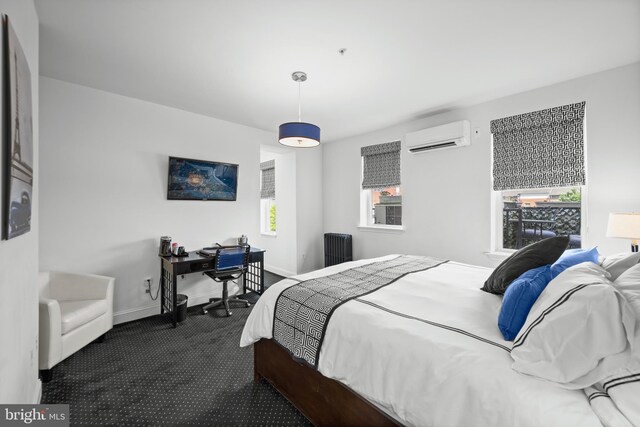 210 S High St, Baltimore, MD 21202 - bedroom with a wall mounted air conditioner, radiator heating unit, dark carpet, and an office area
