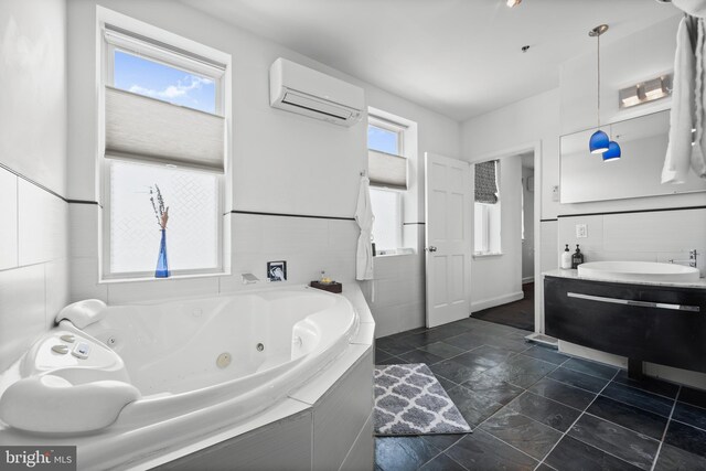 210 S High St, Baltimore, MD 21202 - bathroom featuring an AC wall unit, a jetted tub, vanity, and stone finish flooring