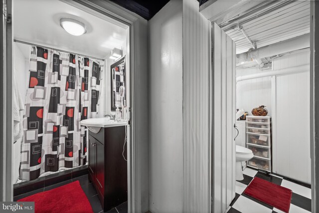 210 S High St, Baltimore, MD 21202 - full bathroom with vanity, tile patterned floors, and curtained shower