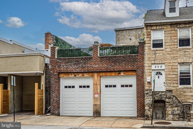 210 S High St, Baltimore, MD 21202 - view of front of home with driveway and stone siding