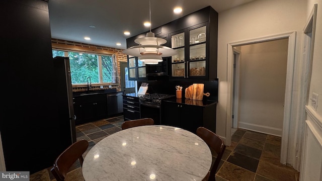 4309 Walther Ave, Baltimore, MD 21214 - kitchen with black range with gas cooktop, dishwasher, dark cabinetry, recessed lighting, and dark countertops