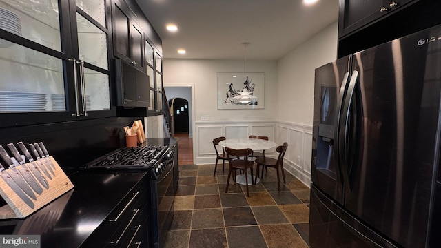 4309 Walther Ave, Baltimore, MD 21214 - kitchen with black appliances, recessed lighting, a wainscoted wall, dark cabinets, and arched walkways