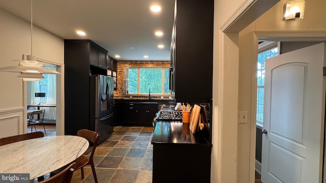 4309 Walther Ave, Baltimore, MD 21214 - kitchen with stainless steel fridge, recessed lighting, dark stone finish floors, and plenty of natural light