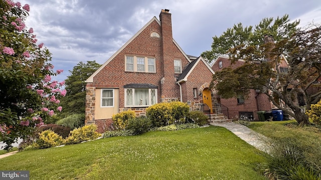 4309 Walther Ave, Baltimore, MD 21214 - tudor-style house featuring a front yard, stone siding, brick siding, and a chimney