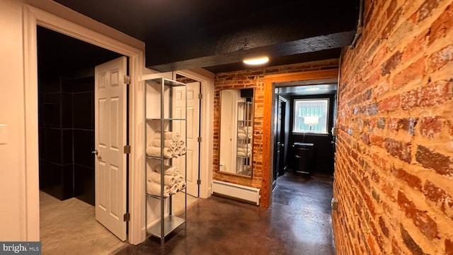 4309 Walther Ave, Baltimore, MD 21214 - hall featuring a baseboard heating unit, concrete floors, and brick wall