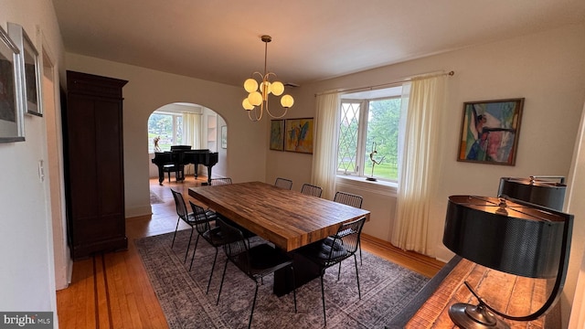 4309 Walther Ave, Baltimore, MD 21214 - dining space featuring arched walkways, light wood-style floors, and a chandelier