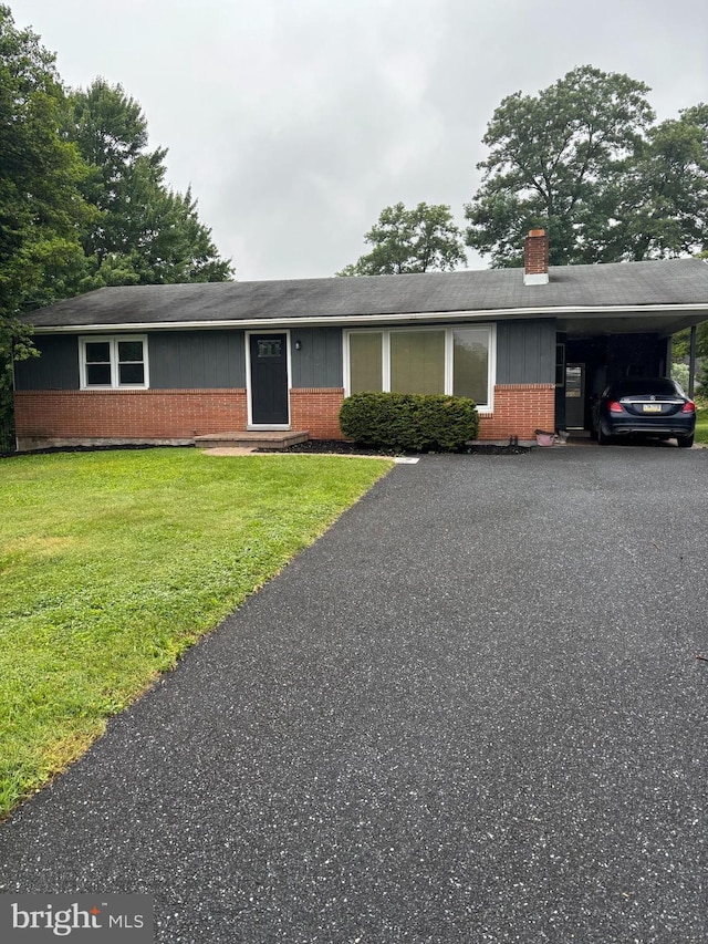 465 Pleasantview Rd, New Cumberland, PA 17070 - single story home featuring brick siding, a chimney, a front lawn, an attached carport, and a shingled roof