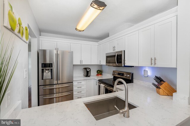 7823 Harrowgate Cir Unit D, Springfield, VA 22152 - kitchen with appliances with stainless steel finishes, light stone countertops, and white cabinetry