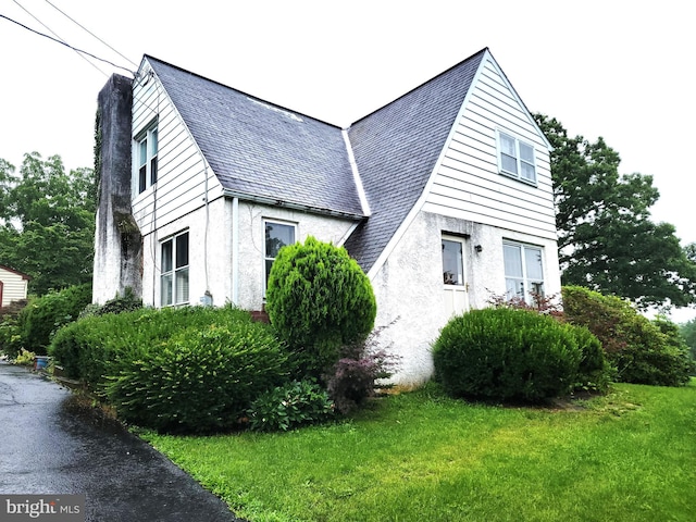 141 Greshville, Boyertown, PA 19512 - view of home's exterior with a chimney, stucco siding, and a lawn