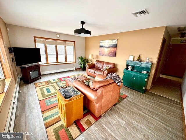 953 Capstan Dr, Forked River, NJ 08731 - living room with wood finished floors and a baseboard radiator
