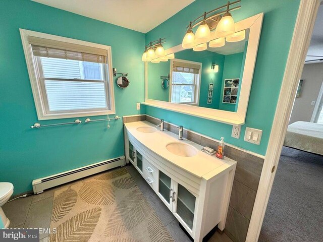 953 Capstan Dr, Forked River, NJ 08731 - ensuite bathroom featuring baseboard heating, double vanity, and tile patterned flooring