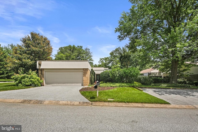 1 Regency Ct Unit 1, Baltimore, MD 21208 - view of front of property featuring brick siding, a front lawn, driveway, and an attached garage